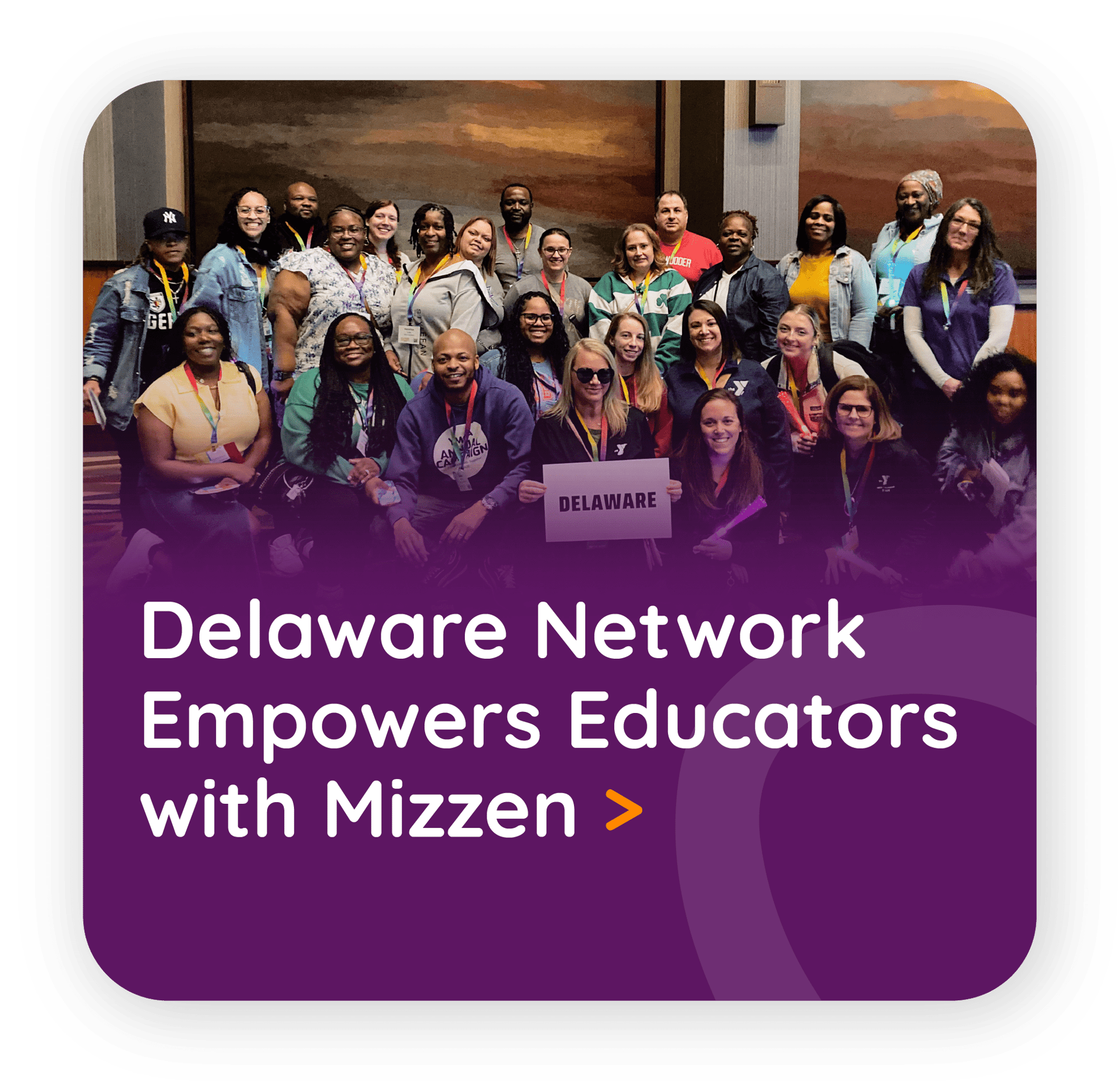 A large smiling group of educators holds up a Delaware sign.